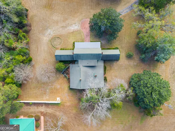 an aerial view of a house with outdoor space and lake view