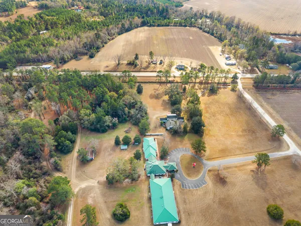 an aerial view of a house with a yard and lake view