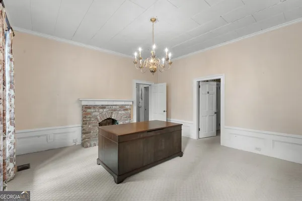 a living room with furniture a chandelier and a fireplace