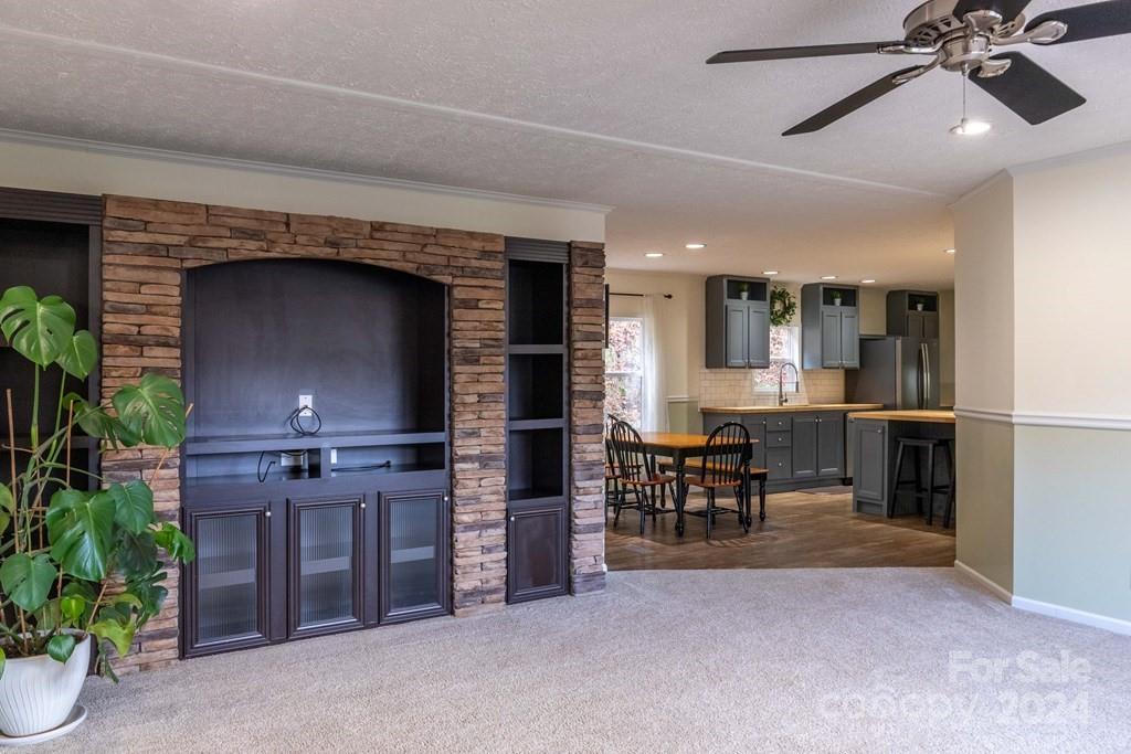 572 Dark Ridge Road Sylva, NC 28779 - Photo 14 of 26 a open kitchen view with stainless steel appliances a dining table chairs and granite counter tops