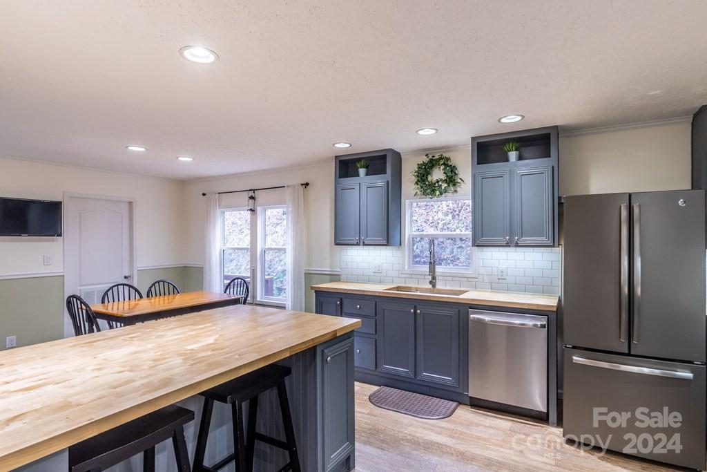 572 Dark Ridge Road Sylva, NC 28779 - Photo 16 of 26 a kitchen with center island and stainless steel appliances