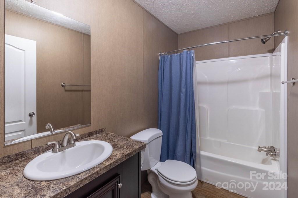 572 Dark Ridge Road Sylva, NC 28779 - Photo 21 of 26 a bathroom with a sink toilet and shower