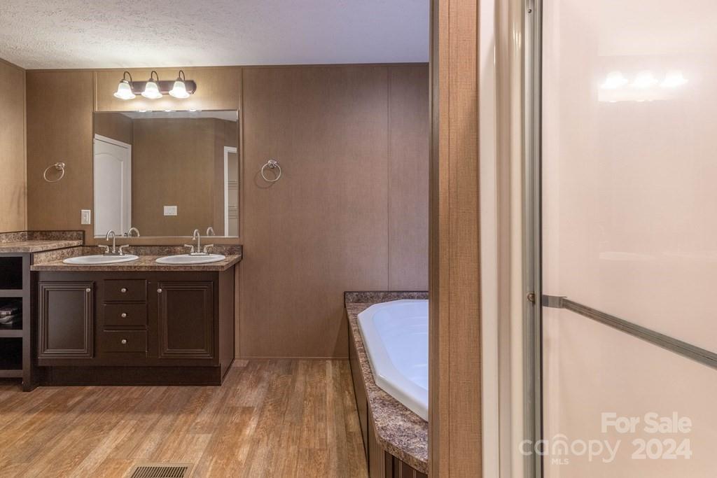 572 Dark Ridge Road Sylva, NC 28779 - Photo 23 of 26 a bathroom with a sink vanity and a mirror