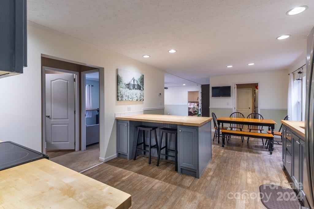 572 Dark Ridge Road Sylva, NC 28779 - Photo 25 of 26 a open kitchen with stainless steel appliances granite countertop a stove refrigerator and dining table