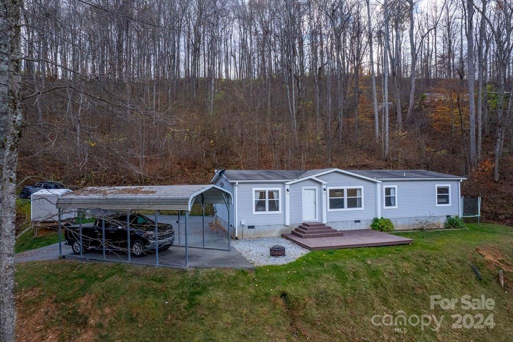 572 Dark Ridge Road Sylva, NC 28779 - Photo 6 of 26 a view of a house with a backyard and a patio