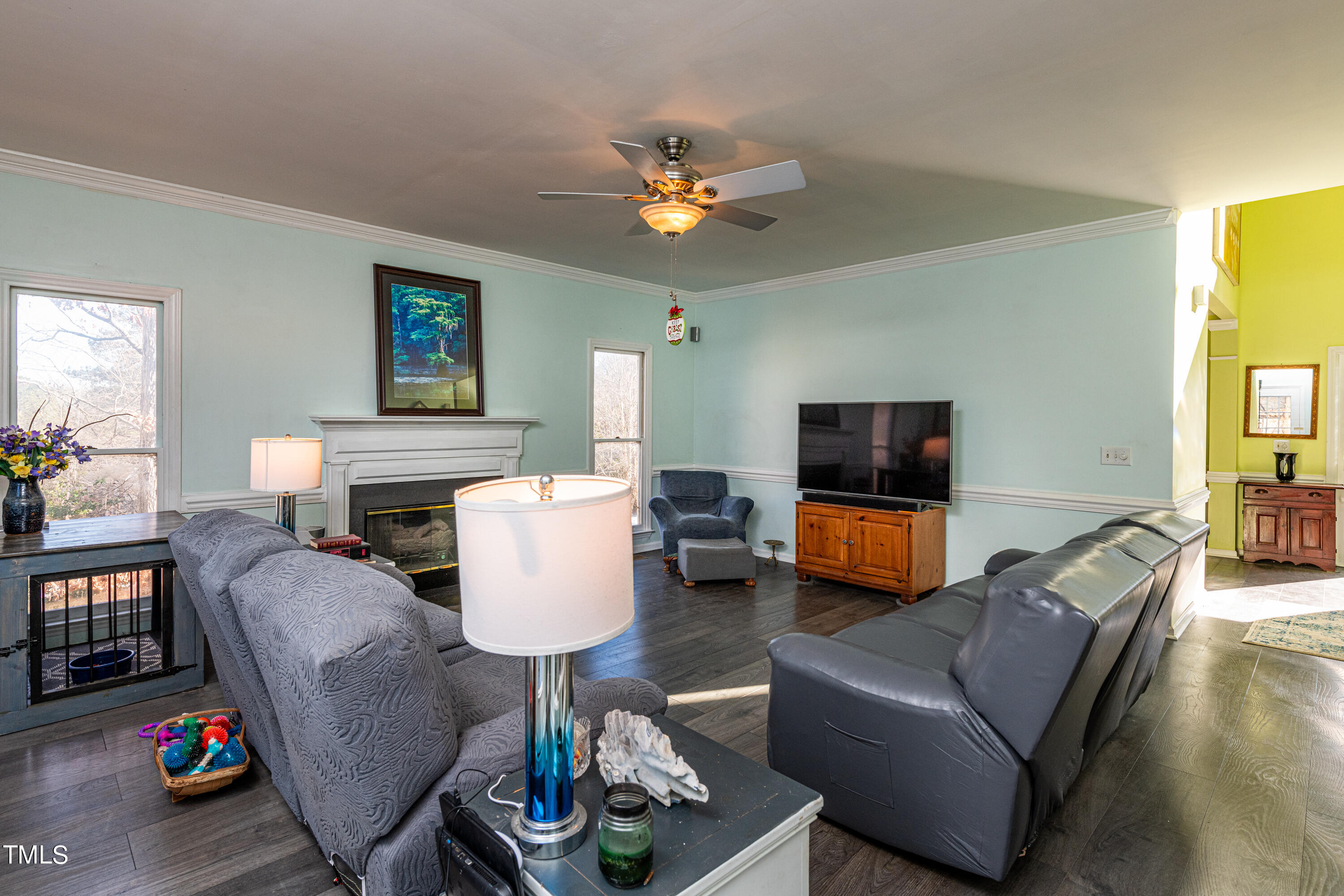 3105 Twatchman Drive Raleigh, NC 27616 - Photo 12 of 38 a living room with furniture a fireplace and a flat screen tv