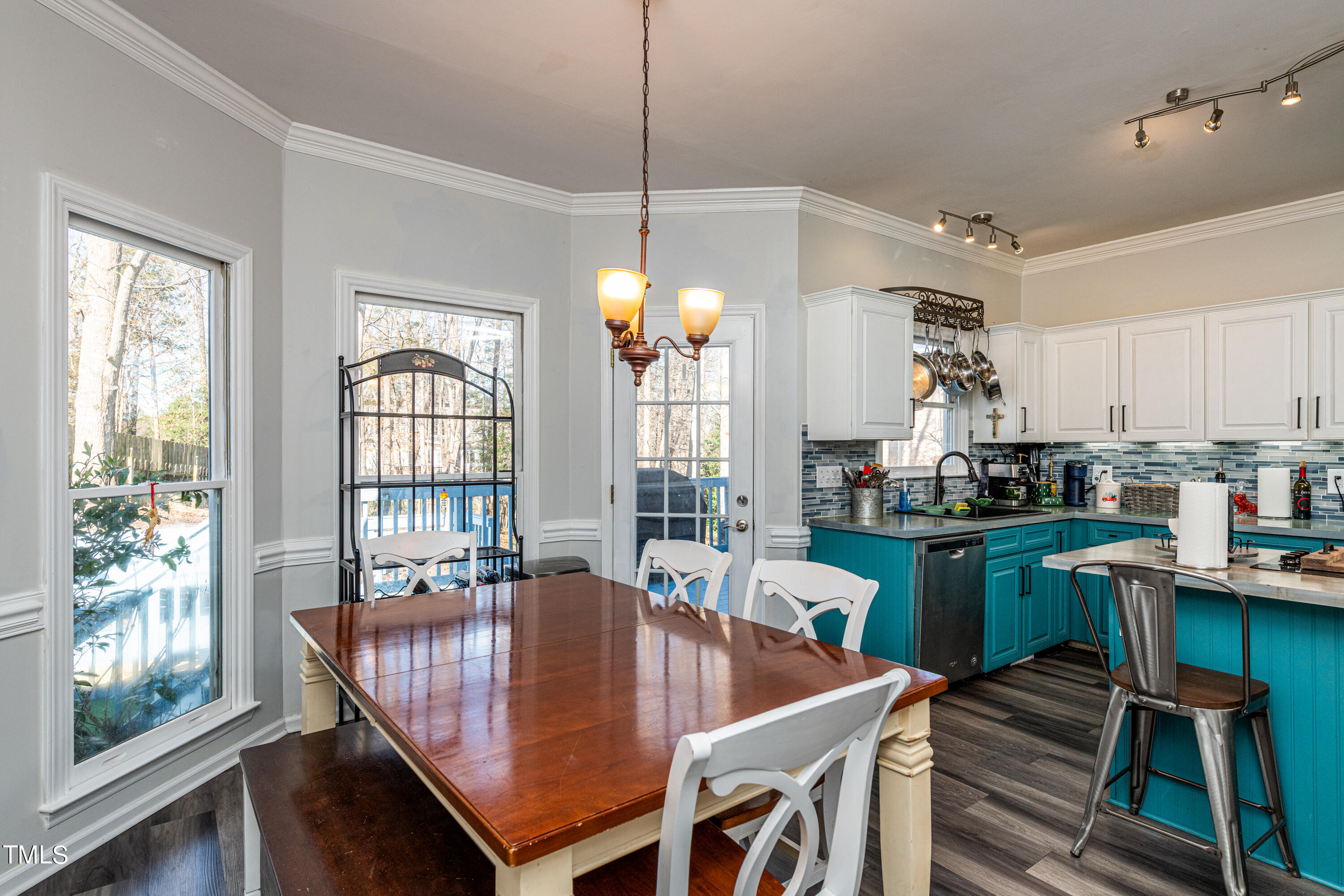 3105 Twatchman Drive Raleigh, NC 27616 - Photo 21 of 38 a dining room with furniture a chandelier and wooden floor