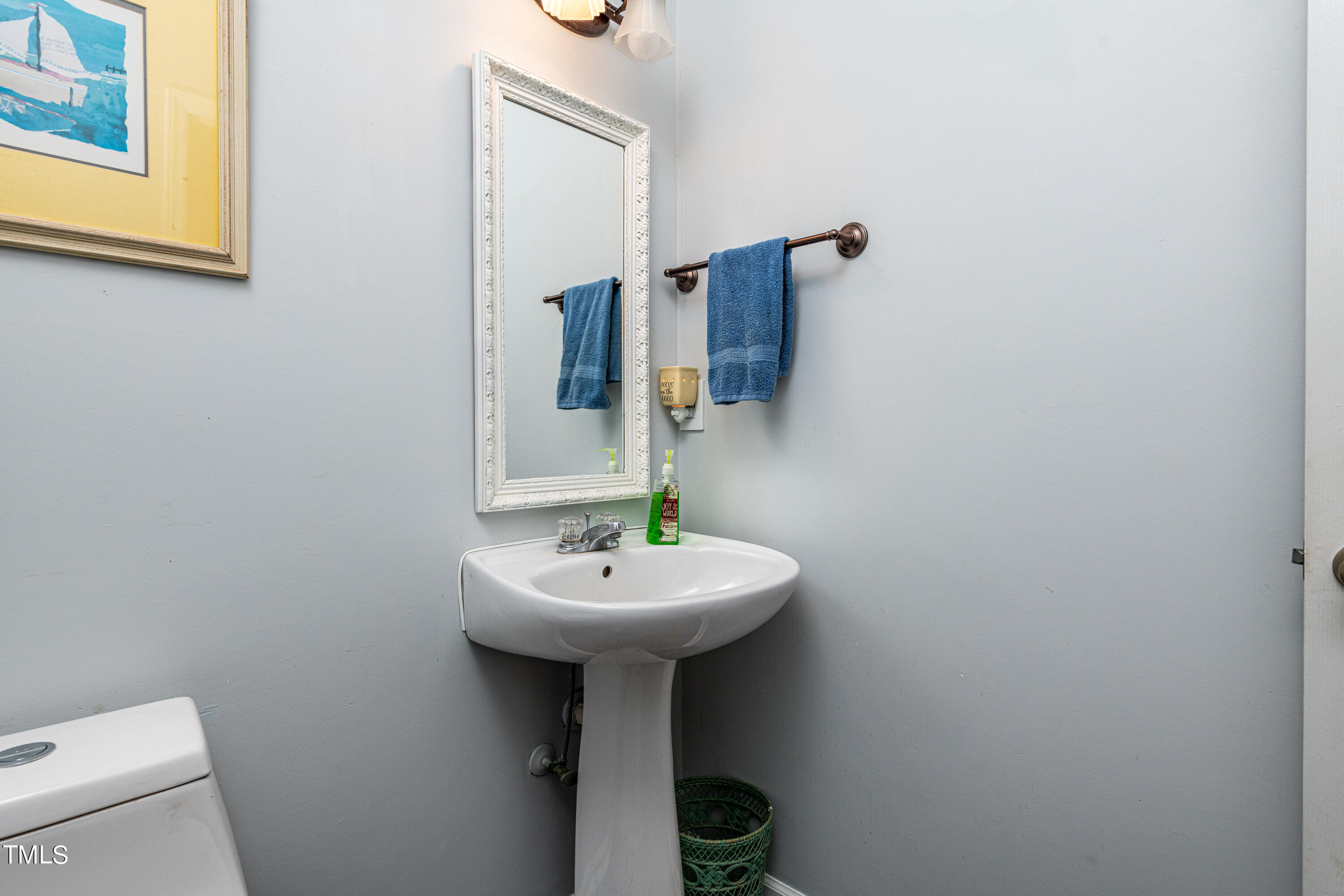 3105 Twatchman Drive Raleigh, NC 27616 - Photo 23 of 38 a bathroom with a sink a mirror and toilet
