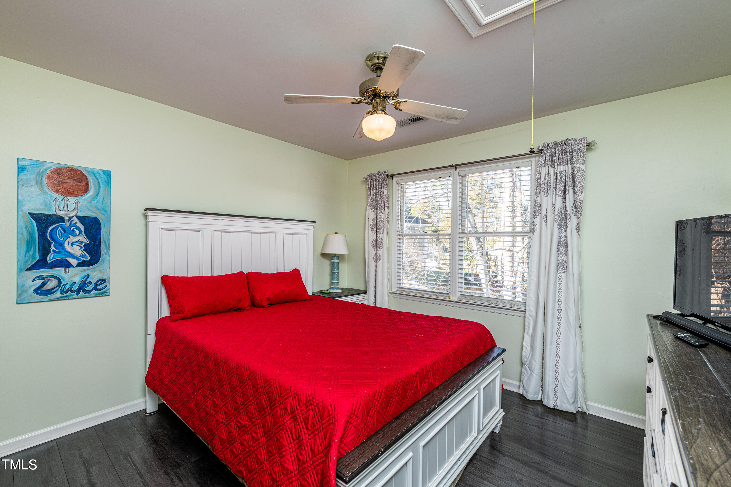 3105 Twatchman Drive Raleigh, NC 27616 - Photo 29 of 38 a bedroom with a bed and a chandelier