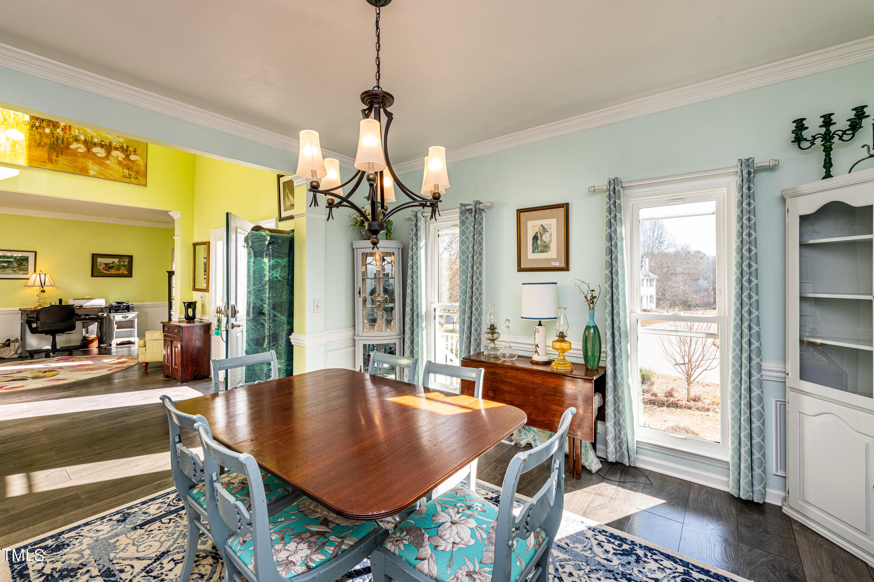 3105 Twatchman Drive Raleigh, NC 27616 - Photo 9 of 38 a dining room with furniture and a chandelier