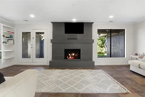 a living room with a large fireplace and a flat screen tv