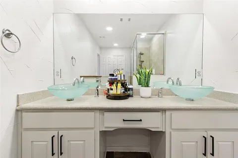 a bathroom with a glass shower door