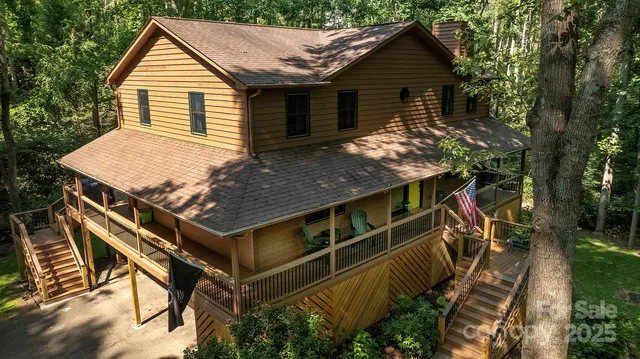 a view of house with yard and sitting area