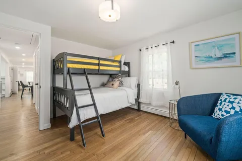 a bedroom with furniture and a window