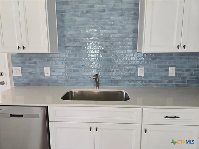 a kitchen with a sink and cabinets