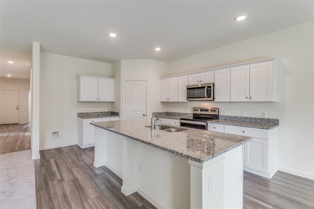 41 Glen Crossings Road Fort Worth, TX 76134 - Photo 2 of 12 a kitchen with granite countertop stainless steel appliances and wooden cabinets