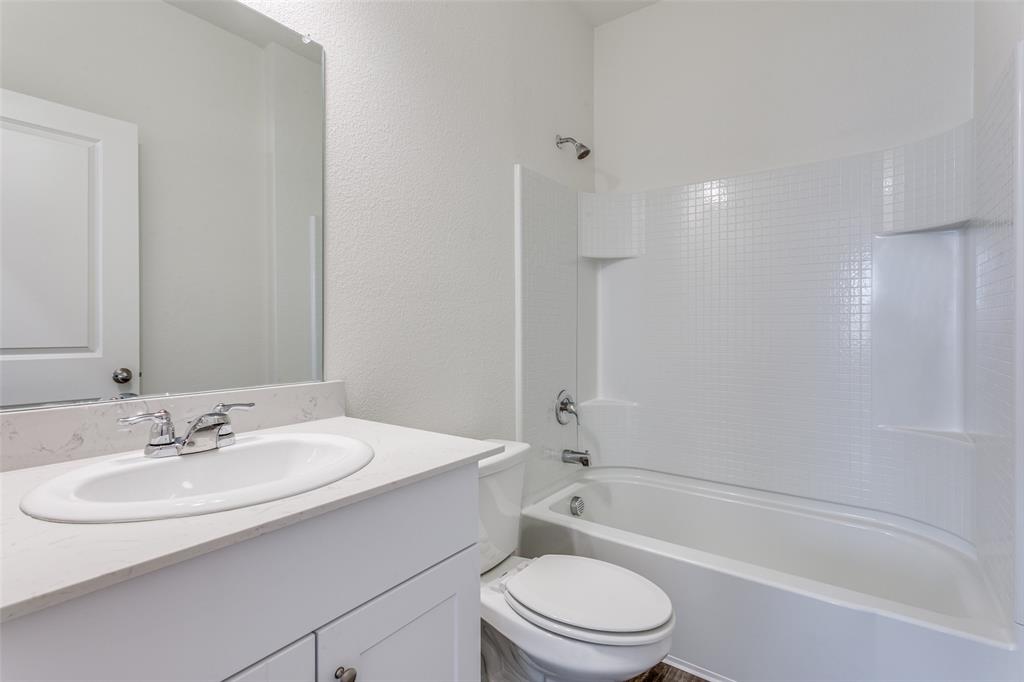 41 Glen Crossings Road Fort Worth, TX 76134 - Photo 9 of 12 a bathroom with a sink toilet and shower