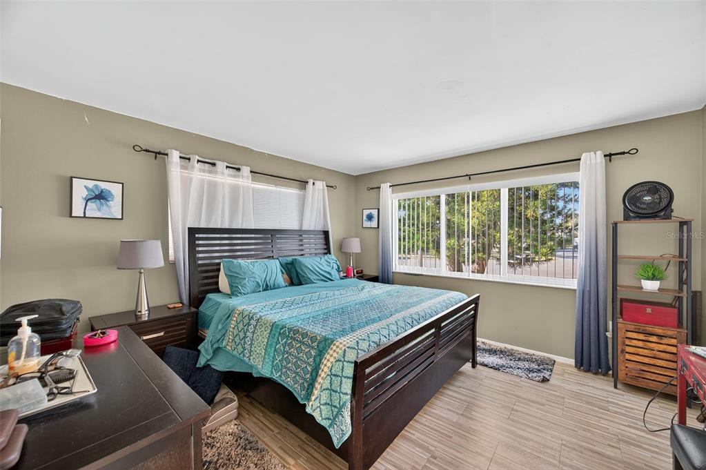 1993 Citrus Hill Road Palm Harbor, FL 34683 - Photo 13 of 37 a bedroom with a bed and wooden floor