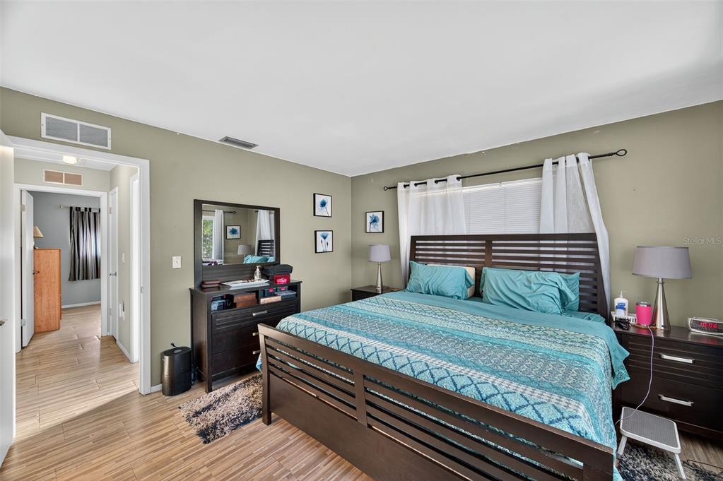 1993 Citrus Hill Road Palm Harbor, FL 34683 - Photo 14 of 37 a bedroom with a bed and wooden floor