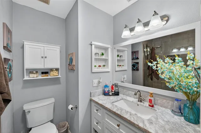 a bathroom with a shower a toilet and a sink