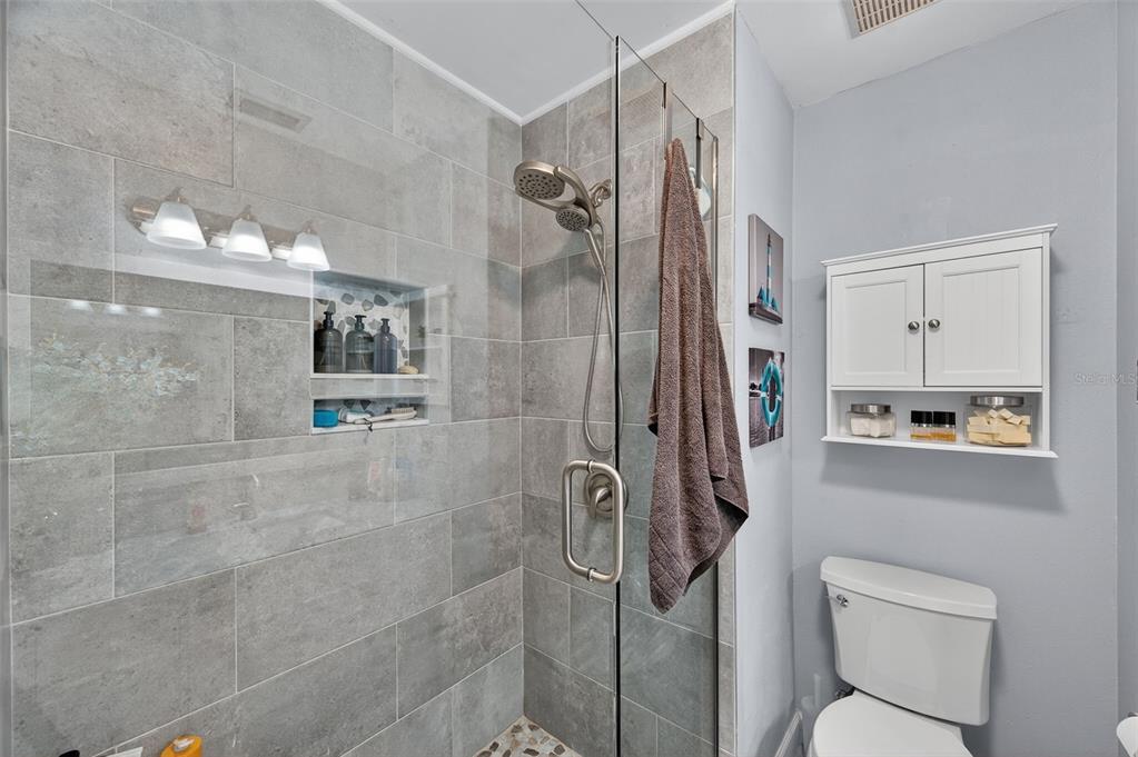 1993 Citrus Hill Road Palm Harbor, FL 34683 - Photo 16 of 37 a bathroom with a shower a toilet and a sink