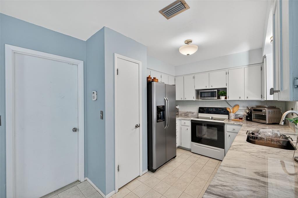 1993 Citrus Hill Road Palm Harbor, FL 34683 - Photo 20 of 37 a kitchen with stainless steel appliances granite countertop a refrigerator and a sink