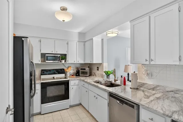 a kitchen filled with a counter space a sink and a window