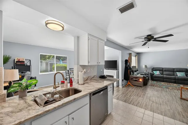 a living room with furniture a flat screen tv and a large window