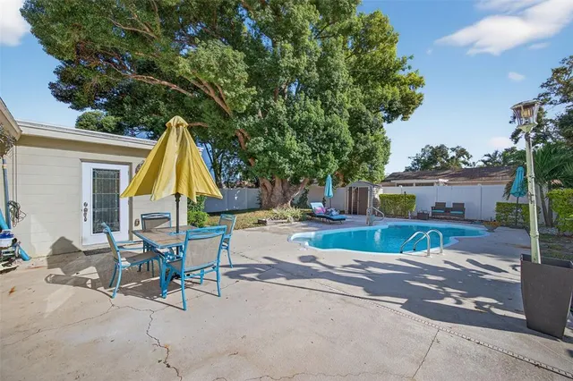 a view of a backyard with plants and outdoor seating