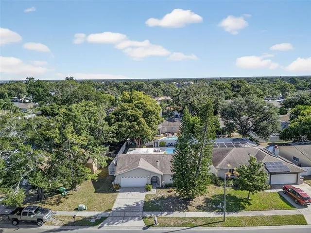 an aerial view of a house with a yard