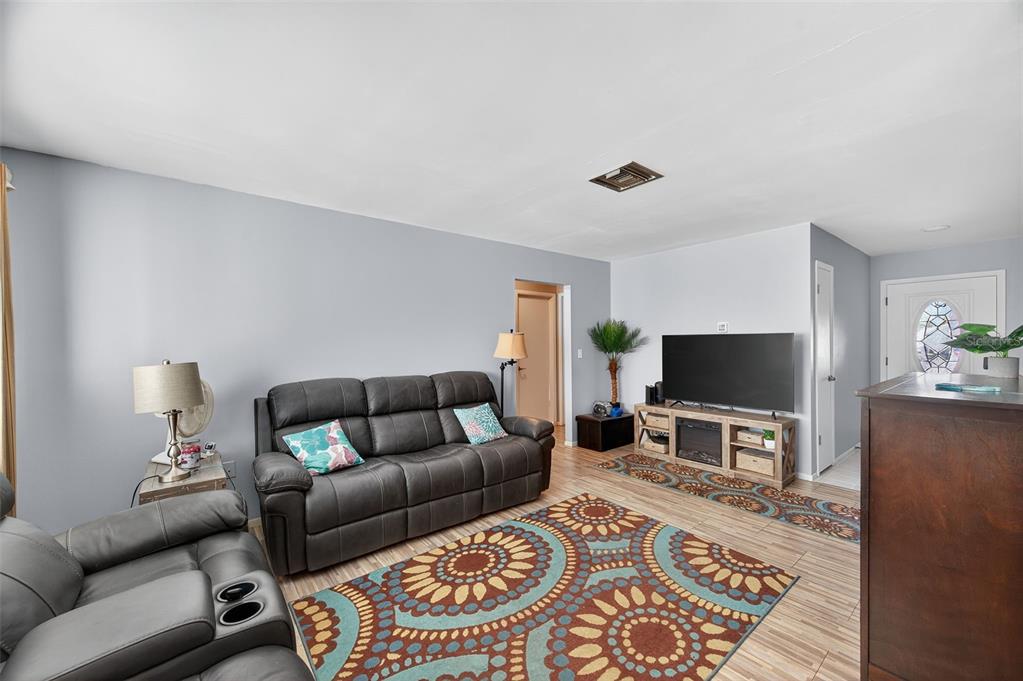 1993 Citrus Hill Road Palm Harbor, FL 34683 - Photo 7 of 37 a living room with furniture and a flat screen tv