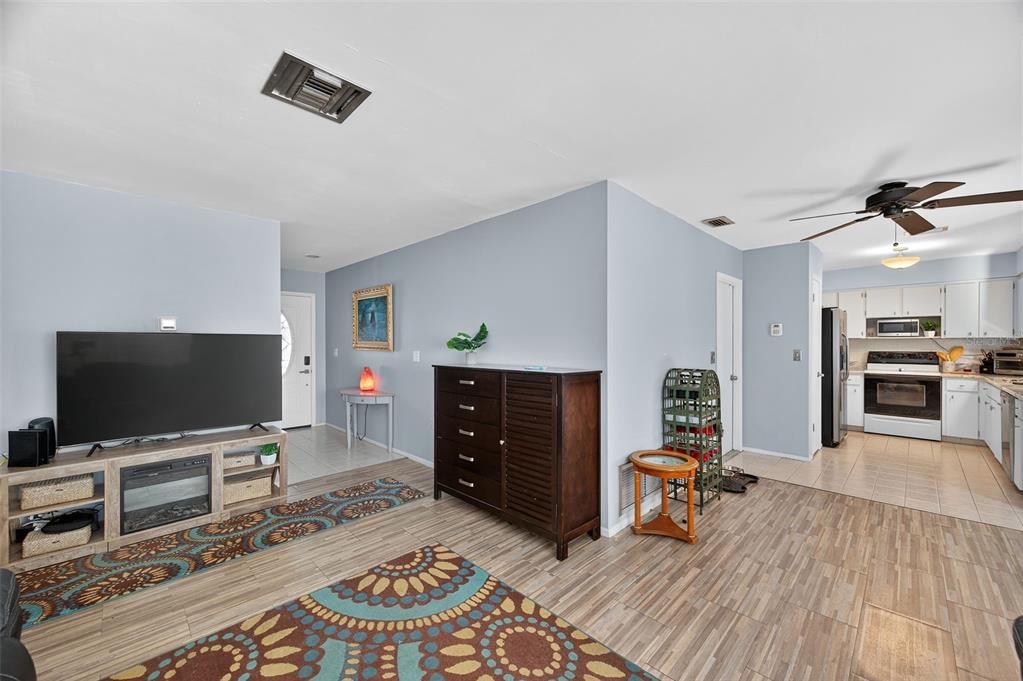 1993 Citrus Hill Road Palm Harbor, FL 34683 - Photo 8 of 37 a living room with furniture and a flat screen tv