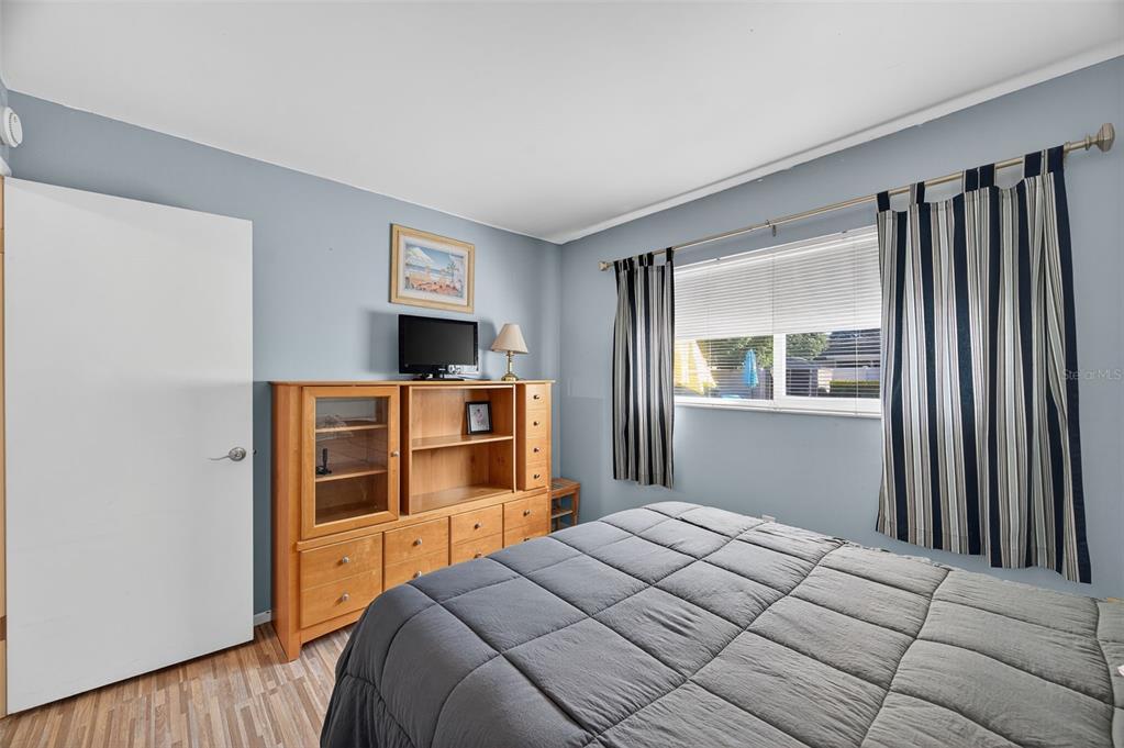 1993 Citrus Hill Road Palm Harbor, FL 34683 - Photo 10 of 37 a bedroom with a bed and a flat screen tv