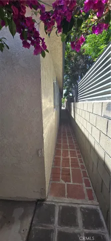 a view of a pathway with a flower garden