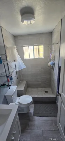 a bedroom with a bed closet and flat tv screen