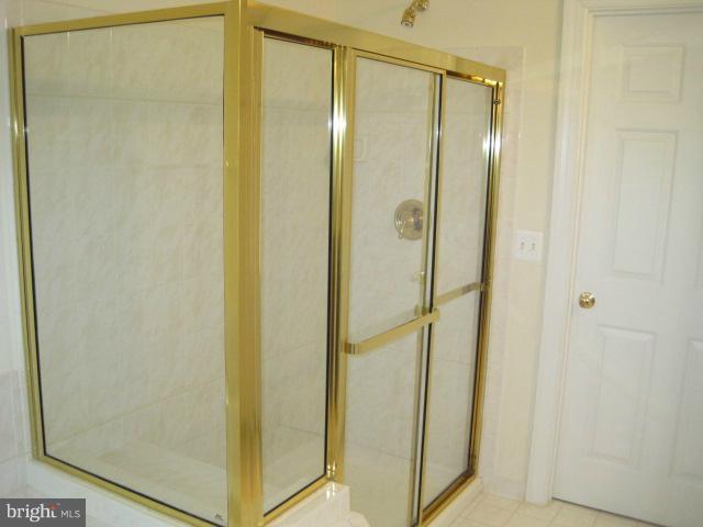 4908 Waple Lane Alexandria, VA 22304 - Photo 14 of 23 a bathroom with a glass shower door