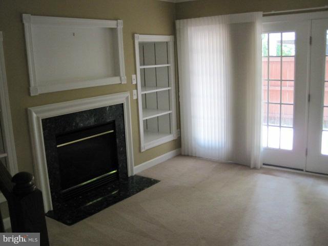 4908 Waple Lane Alexandria, VA 22304 - Photo 20 of 23 an empty room with windows and fireplace