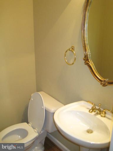 4908 Waple Lane Alexandria, VA 22304 - Photo 3 of 23 a bathroom with a toilet sink and mirror
