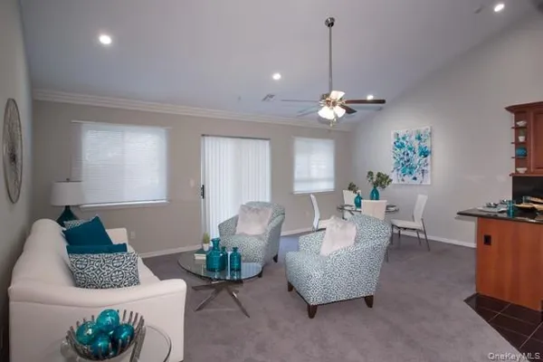 a living room with furniture and a chandelier