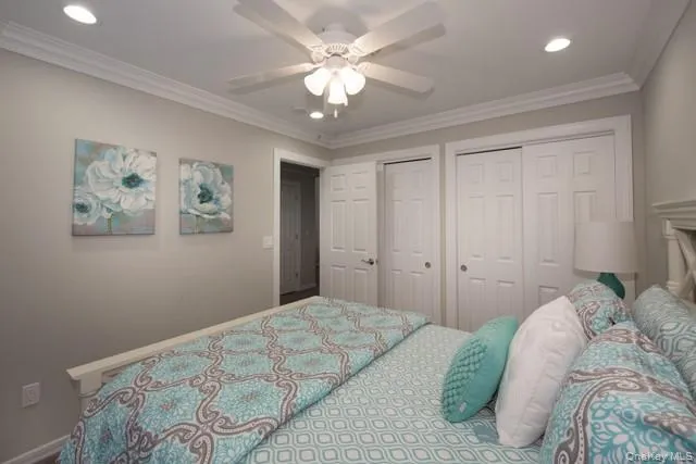 a bedroom with a large bed and a chandelier