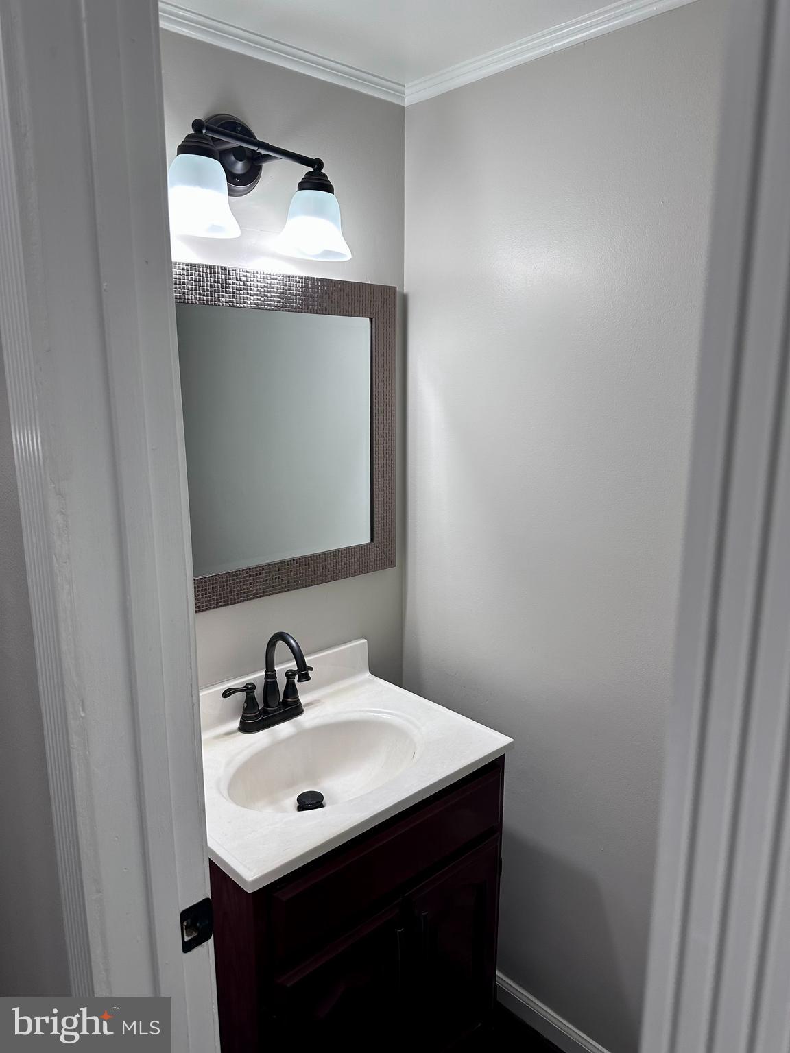 2103 Glencourse Lane Reston, VA 20191 - Photo 14 of 17 a bathroom with a sink and a mirror