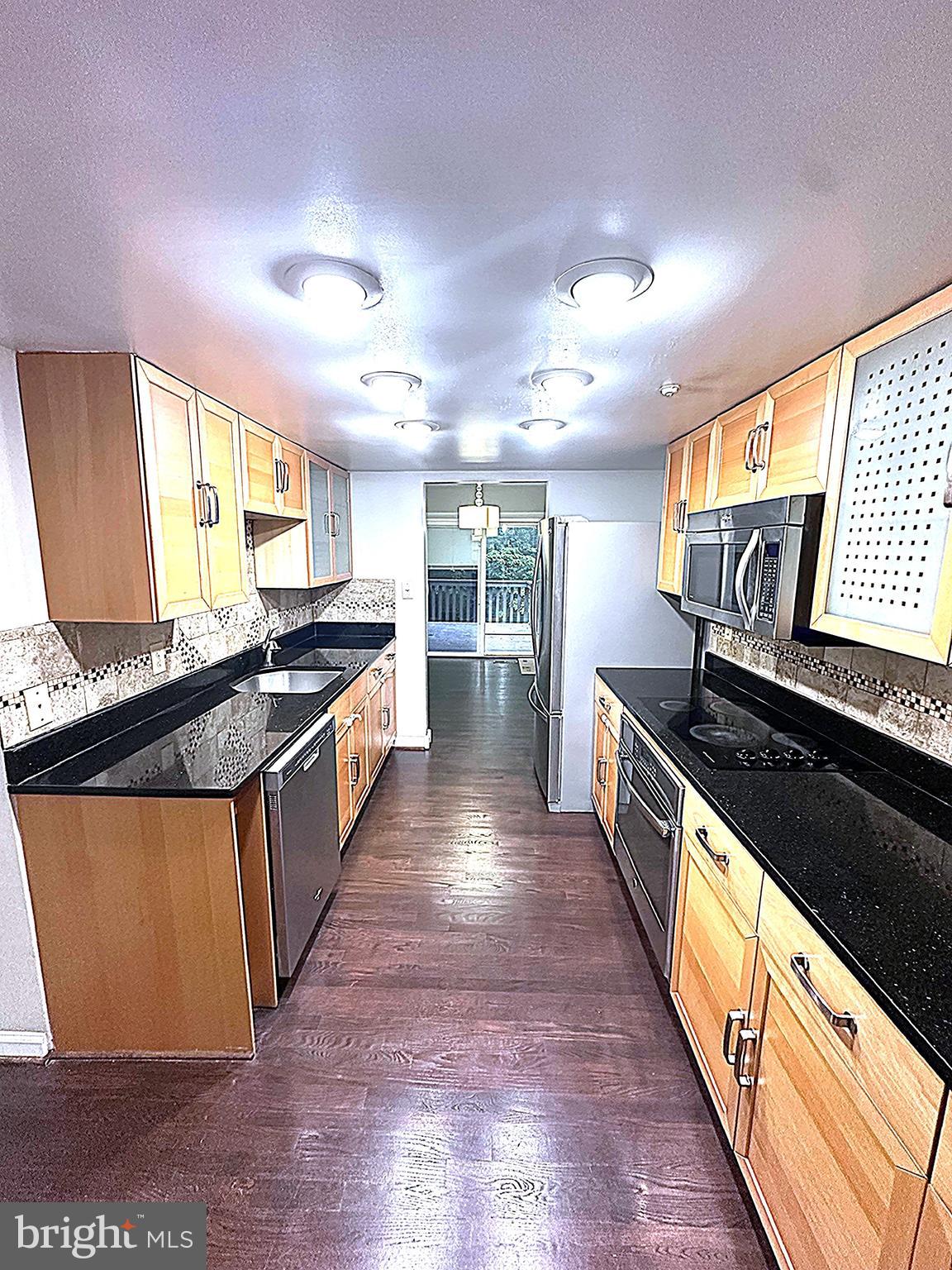2103 Glencourse Lane Reston, VA 20191 - Photo 3 of 17 a large kitchen with stainless steel appliances granite countertop a stove and a sink