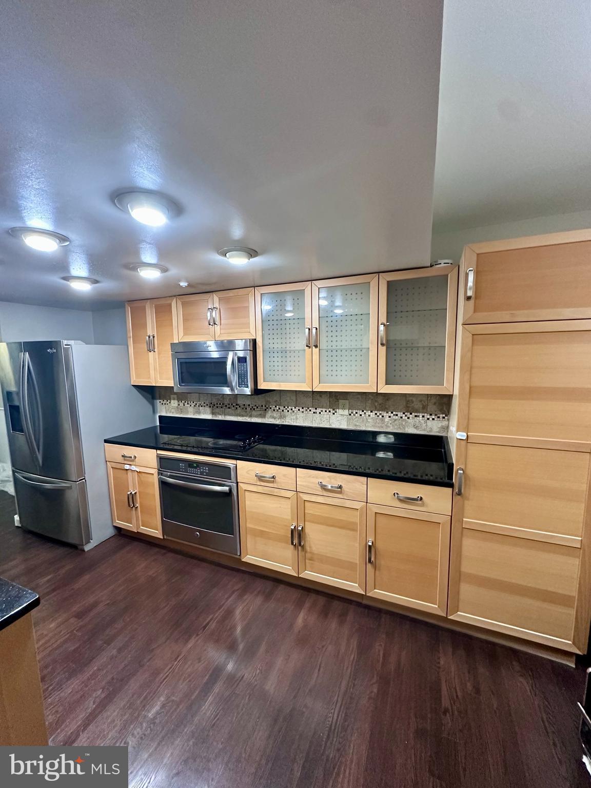 2103 Glencourse Lane Reston, VA 20191 - Photo 5 of 17 a kitchen with stainless steel appliances wooden floor and a counter top space