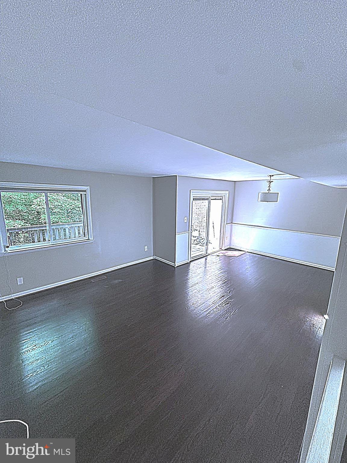 2103 Glencourse Lane Reston, VA 20191 - Photo 7 of 17 an empty room with wooden floor and windows