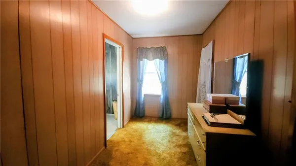 a bedroom with a bed and a mirror