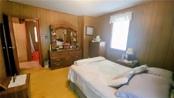 a view of a room with a door and wooden floor