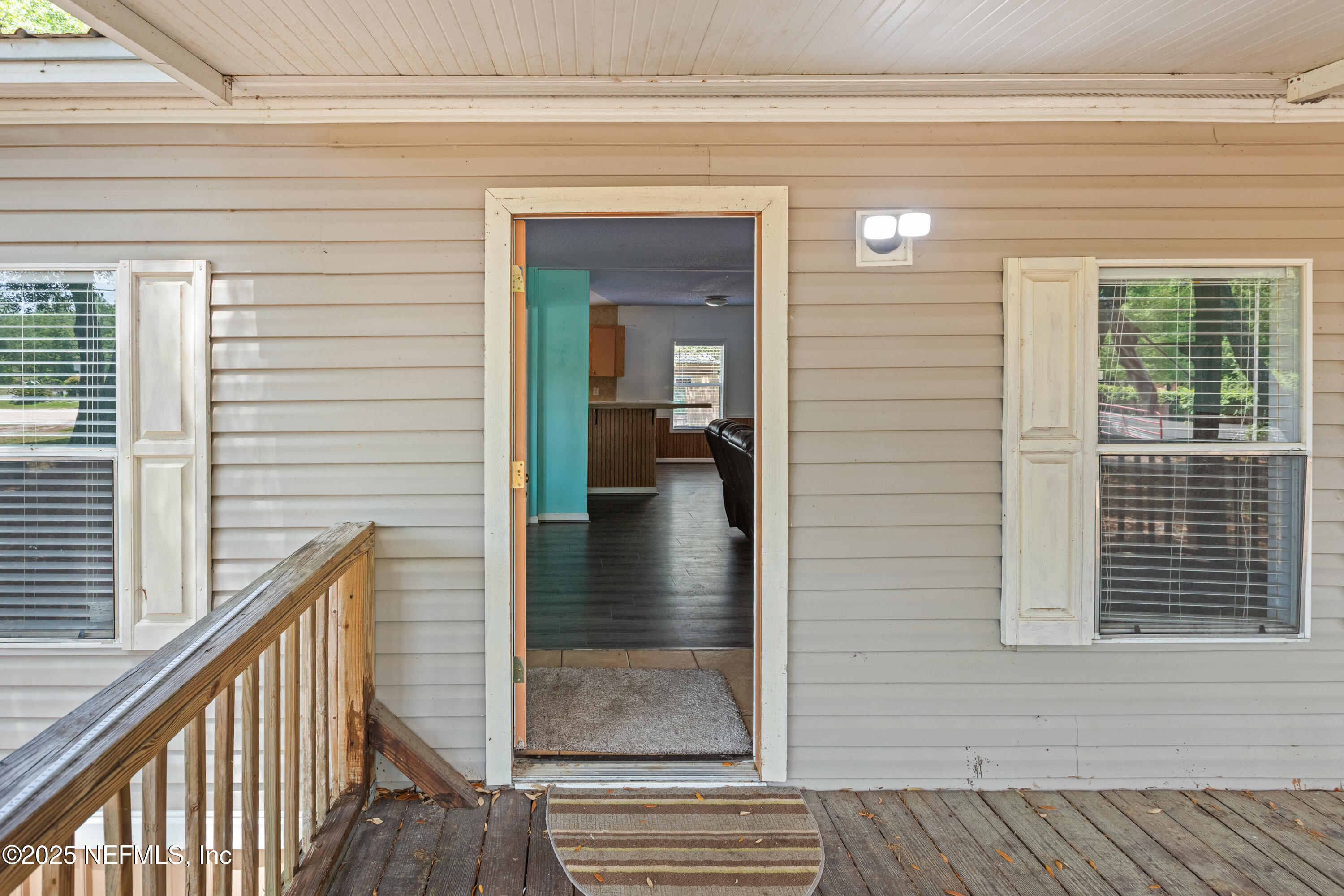 8186 County Line Road Melrose, FL 32666 - Photo 17 of 42 a view of a hallway with wooden floor and staircase