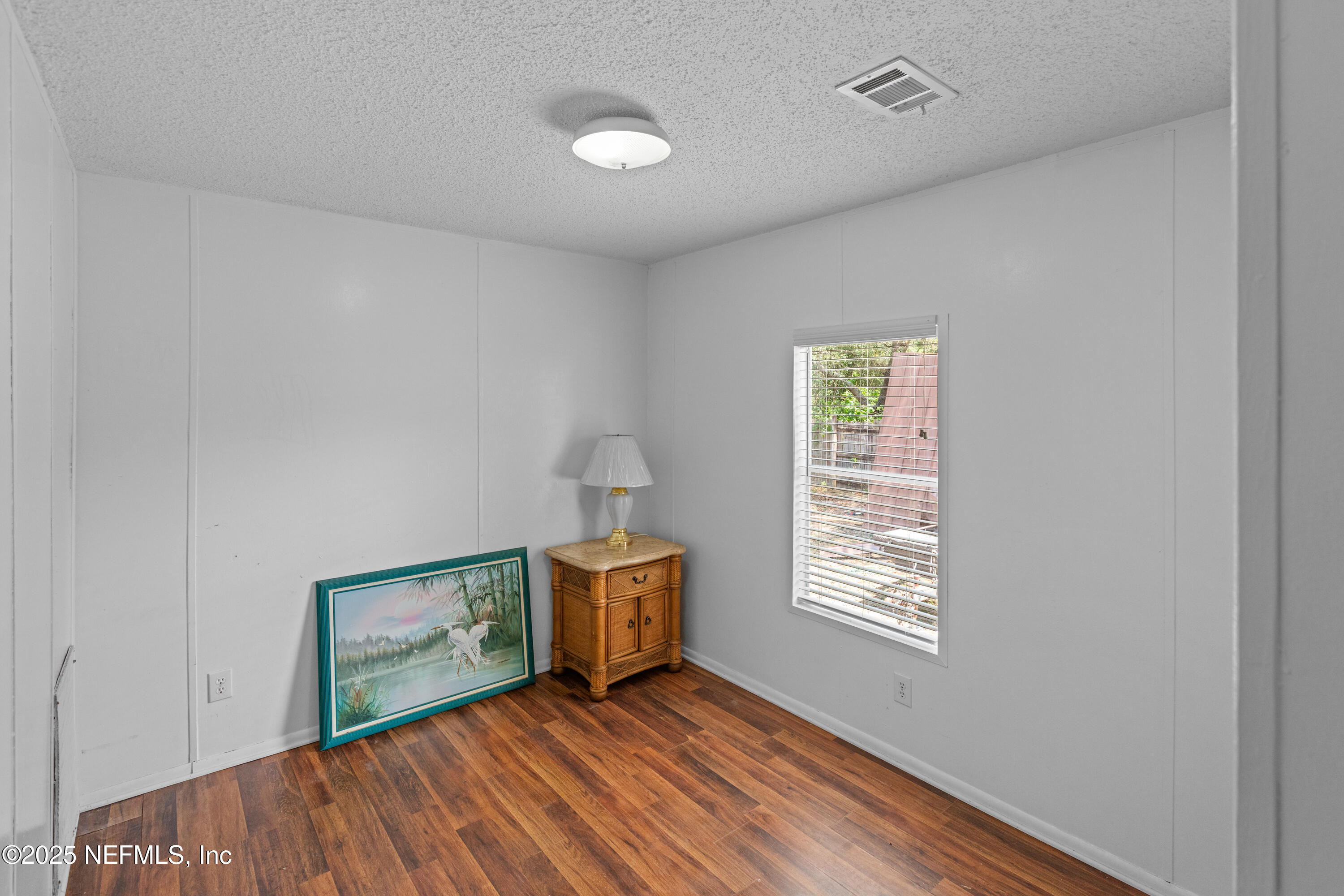 8186 County Line Road Melrose, FL 32666 - Photo 24 of 42 a view of an empty room with window and wooden floor