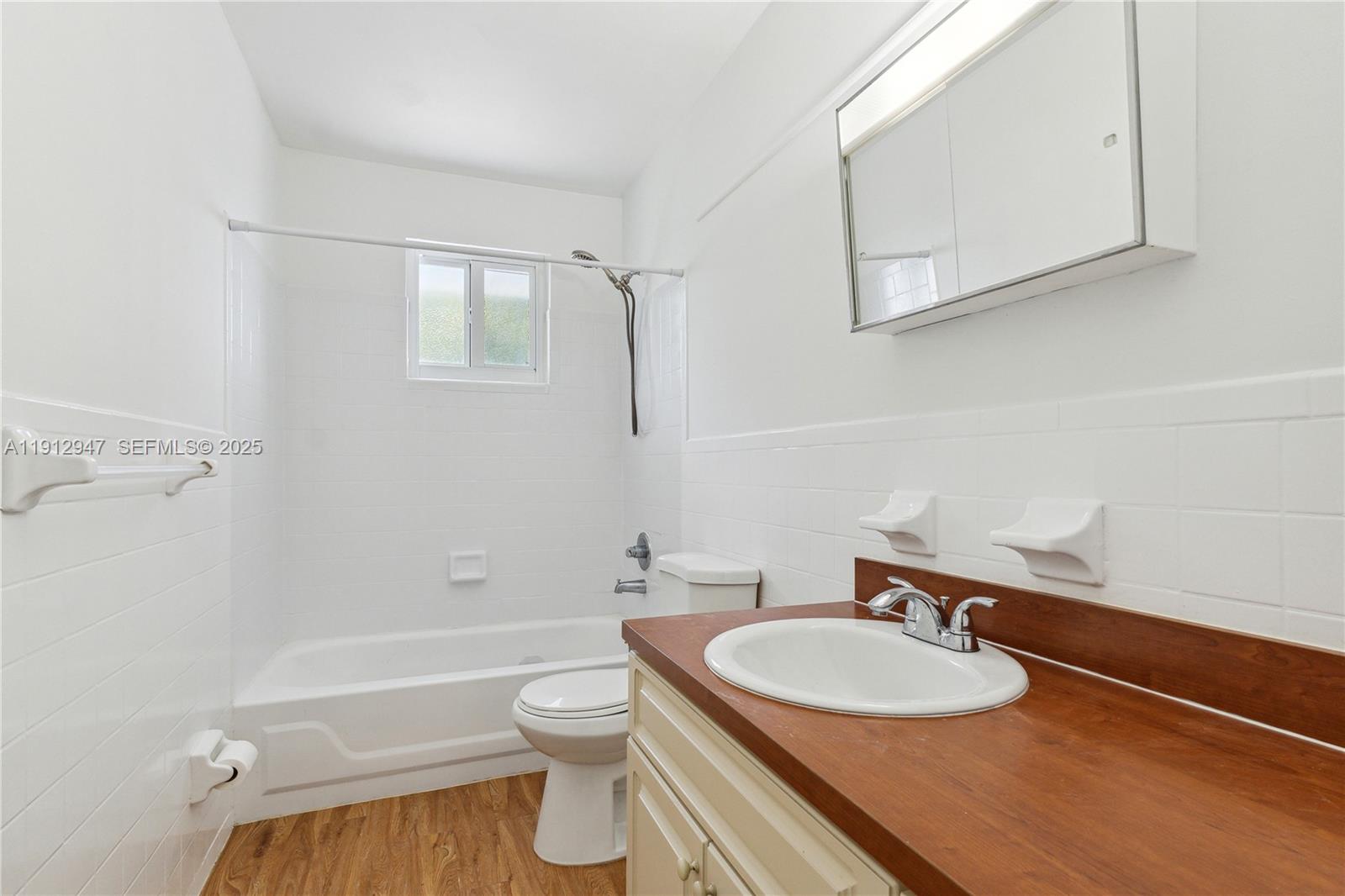 793 Northwest 91st Street, Unit 2 Miami, FL 33150 - Photo 5 of 9 a bathroom with a sink a toilet and shower