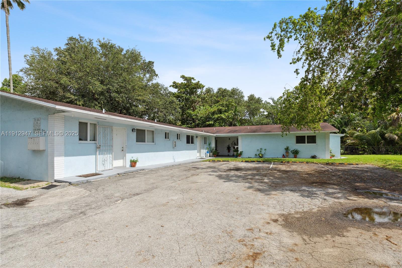 793 Northwest 91st Street, Unit 2 Miami, FL 33150 - Photo 9 of 9 a house with trees in the background